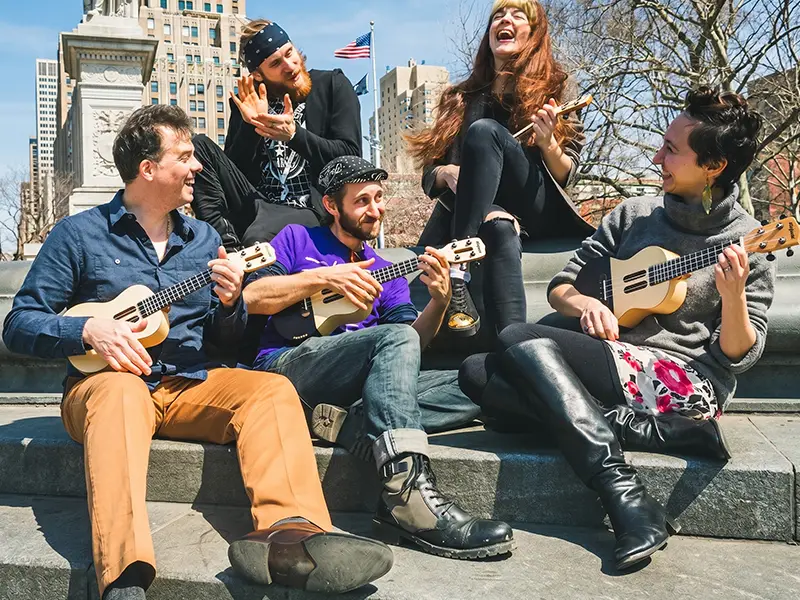 A band is playing songs using populele and popputar.