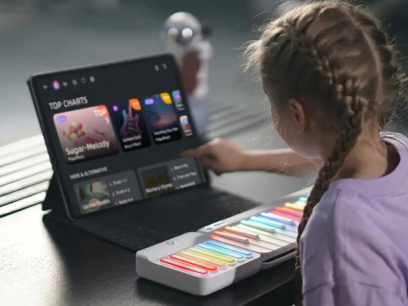 A young girl practicing piano techniques with the PopuPiano smart keyboard